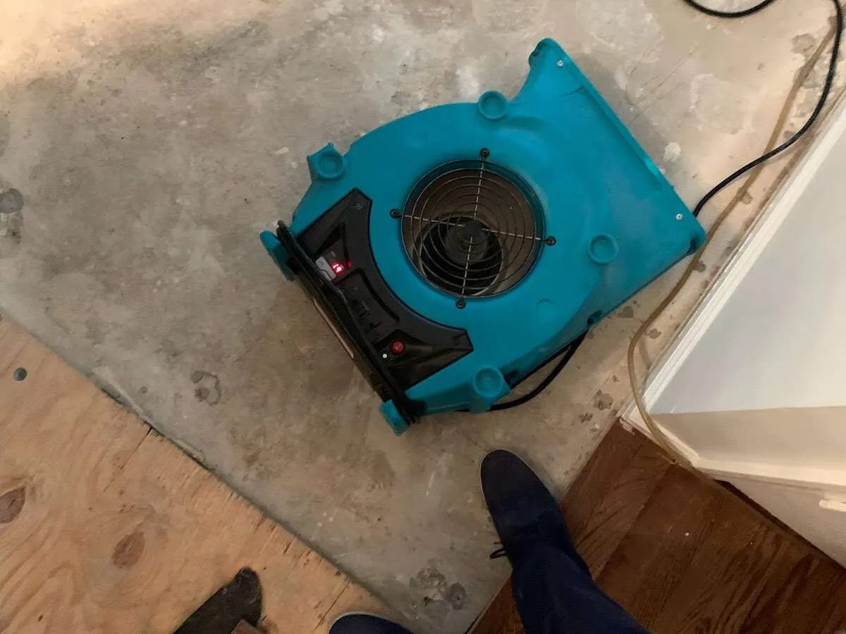 Air mover drying subfloor during Leak Detection & Repair in Tyngsborough